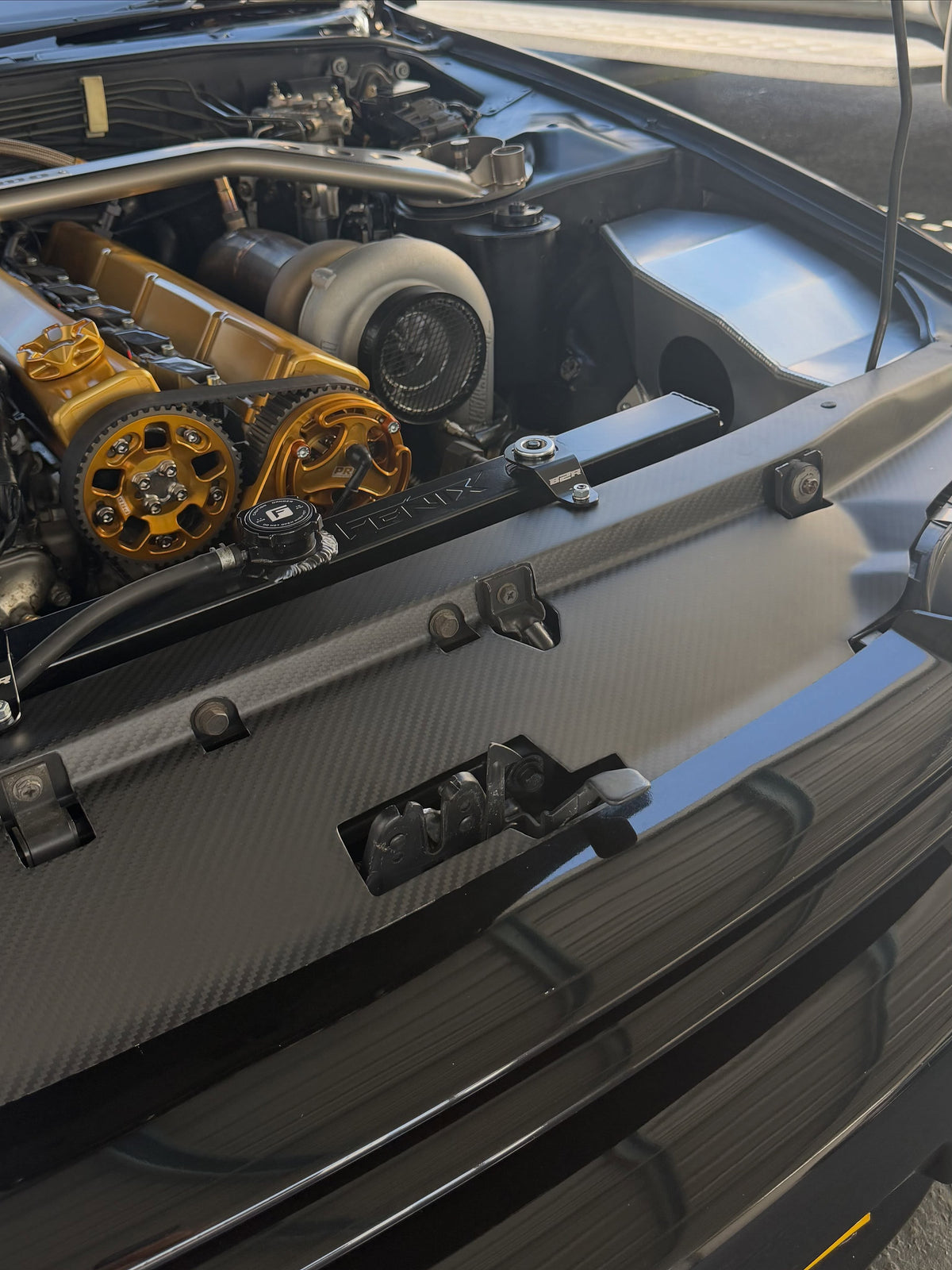 Close-up of Carbonetics dry carbon cooling panel and carbon weave fitted to a customer Nissan Skyline R32 GT-R
